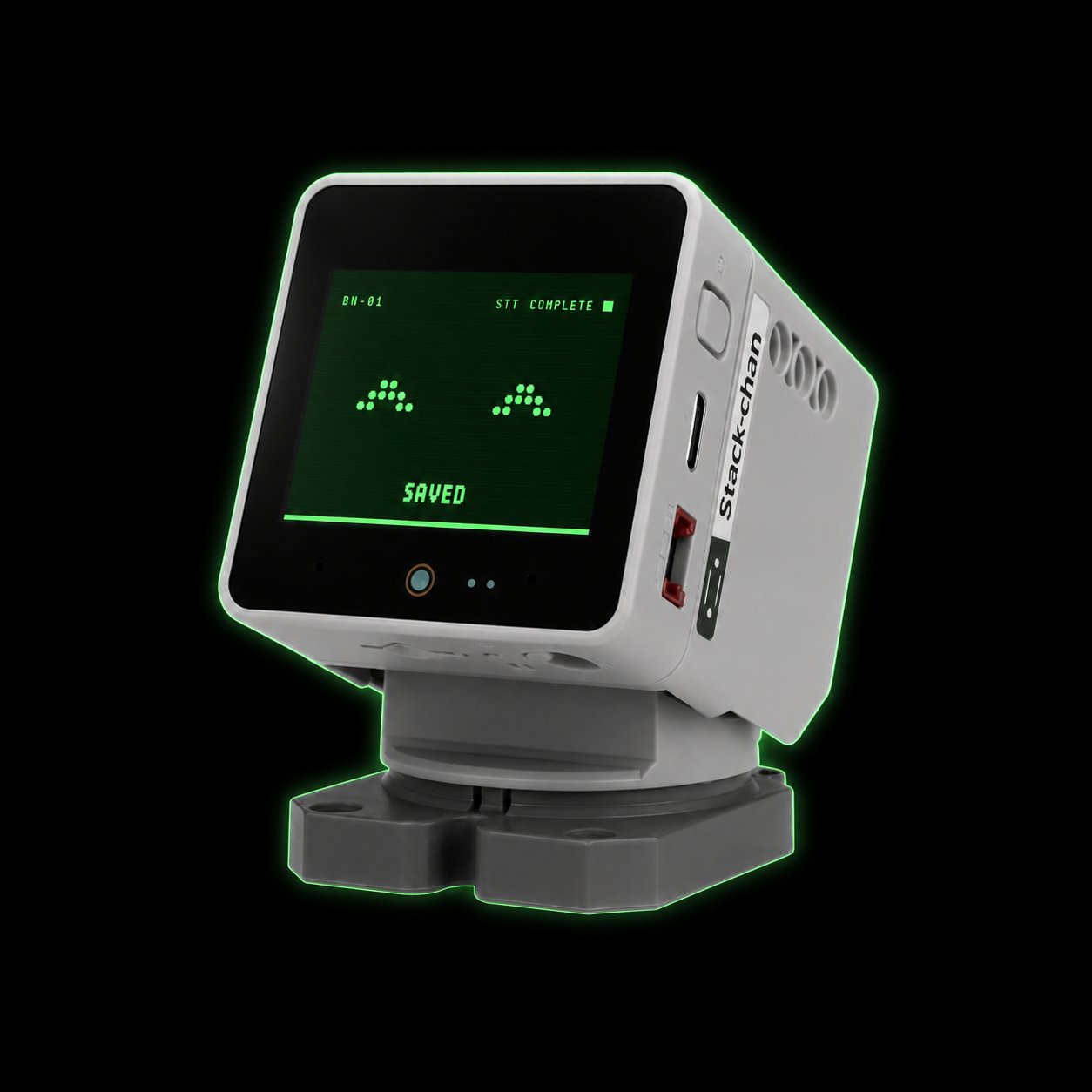 黒い画面に緑色の表情を表示した卓上AI同席ロボットの試作イメージ